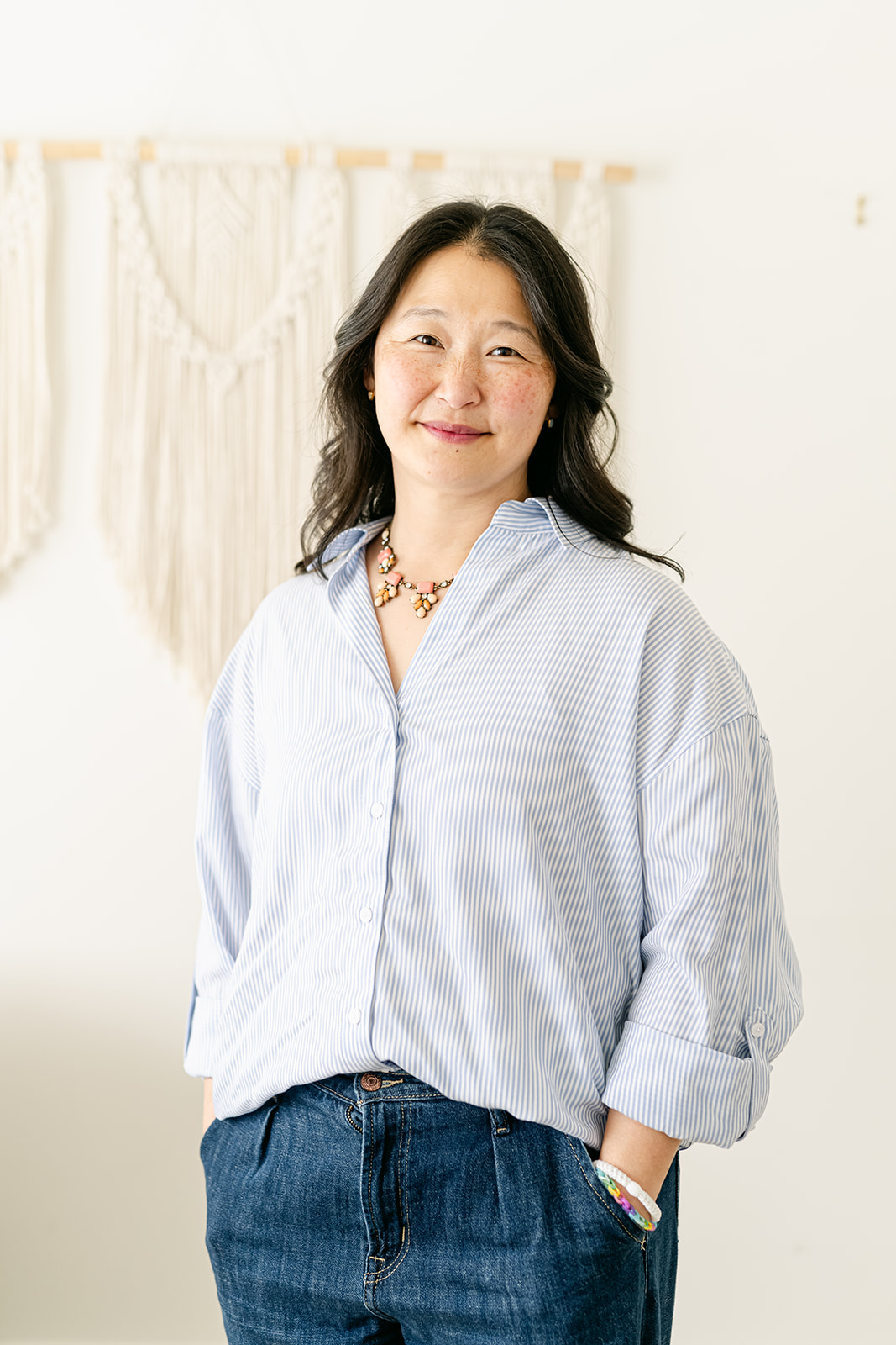 Dr. Janice Wu standing in a bright studio